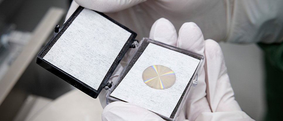 Gloved hands handling component