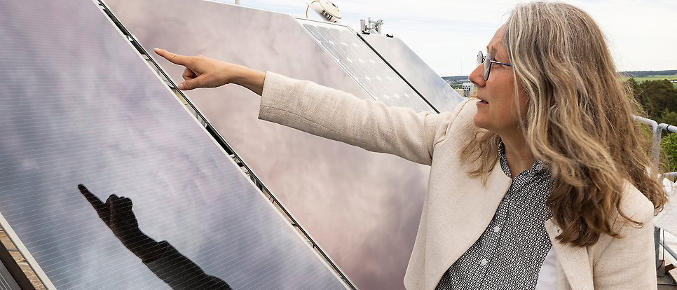 Person pointing at solar panel