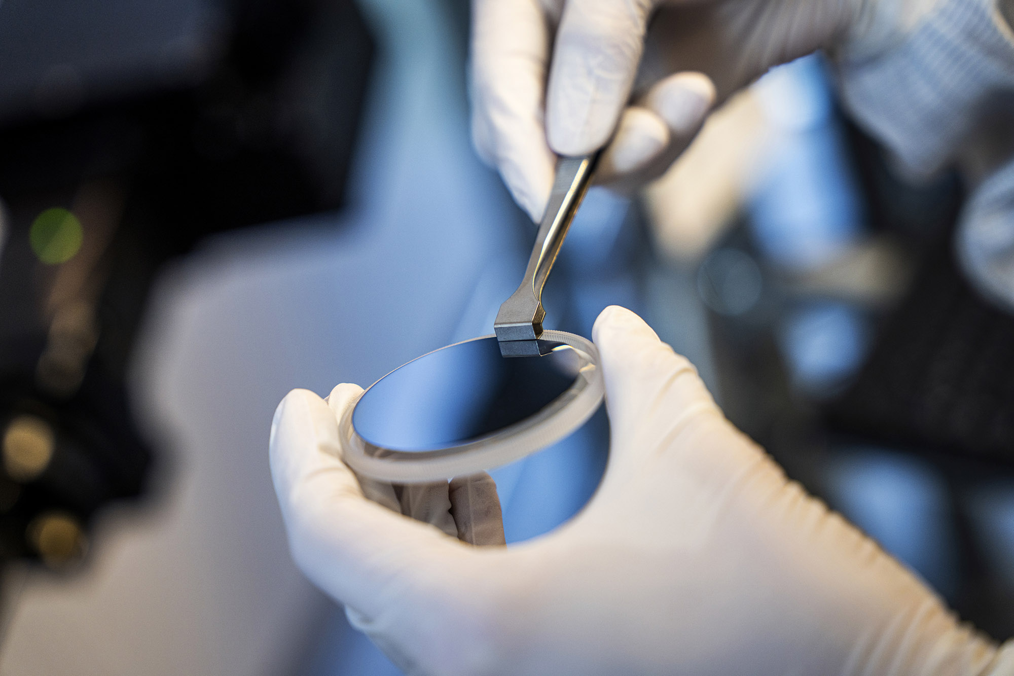 Closeup photo of hand delicately handling object with a tool